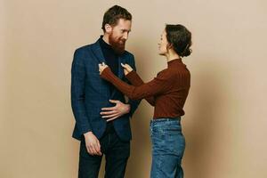 Man and woman couple in a relationship smile and interaction on a beige background in a real relationship between people photo