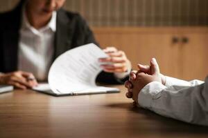 Image of employer or recruiter holding reading a resume during about colloquy his profile of candidate. photo