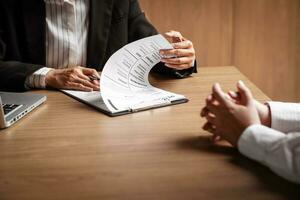 Image of employer or recruiter holding reading a resume during about colloquy his profile of candidate. photo