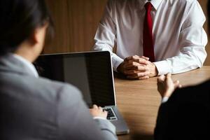 Image of employer or recruiter holding reading a resume during about colloquy his profile of candidate. photo