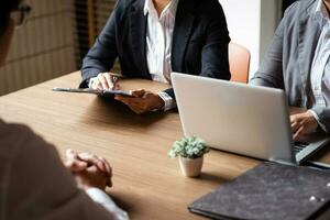 Image of employer or recruiter holding reading a resume during about colloquy his profile of candidate. photo