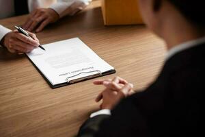 Image of employer or recruiter holding reading a resume during about colloquy his profile of candidate. photo