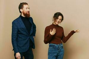 Man and woman couple in a relationship smile and interaction on a beige background in a real relationship between people photo