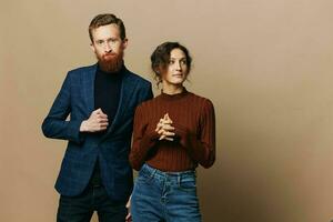 Man and woman couple in a relationship smile and interaction on a beige background in a real relationship between people photo