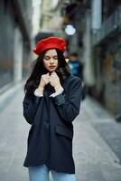 Fashion woman portrait walking tourist in stylish clothes with red lips walking down narrow city street, travel, cinematic color, retro vintage style, dramatic look without smile sadness. photo