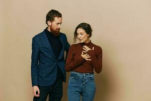 Man and woman couple in a relationship smile and interaction on a beige background in a real relationship between people photo