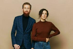 Man and woman couple in a relationship smile and interaction on a beige background in a real relationship between people photo