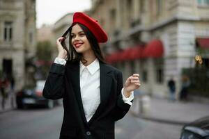 Fashion woman portrait smile with teeth standing on the street in the city background in stylish clothes red lips and red beret, travel, cinematic color, retro vintage style, urban fashion lifestyle. photo