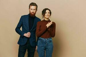 Man and woman couple in a relationship smile and interaction on a beige background in a real relationship between people photo