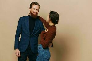 Man and woman couple in a relationship smile and interaction on a beige background in a real relationship between people photo