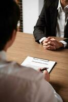 Image of employer or recruiter holding reading a resume during about colloquy his profile of candidate. photo