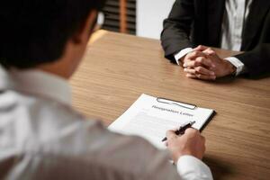 Image of employer or recruiter holding reading a resume during about colloquy his profile of candidate. photo