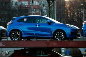 New Ford Puma ST-Line 2021. Creative sunset low light photoshoot. Part of a massive 500 car freight train. photo