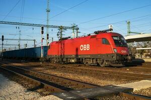 OEBB Austrian Railways cargo freight train with Siemens Taurus 1116 129-8 Locomotive at Budapest Kelenfold railway train station. photo