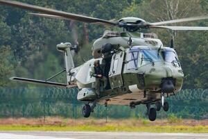 Military helicopter at air base. Air force flight operation. Aviation and aircraft. Air defense. Military industry. photo