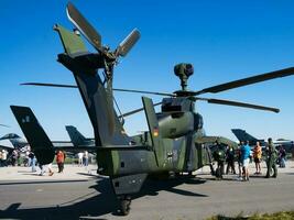 Military helicopter at air base. Air force flight transportation. Aviation and rotorcraft. Transport and airlift. Military industry. Fly and flying. photo