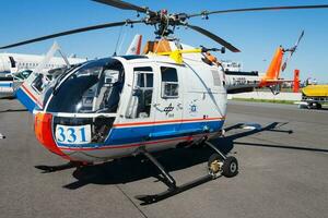 Commercial helicopter at airport and airfield. Rotorcraft. General aviation industry. Civil utility transportation. Air transport. Fly and flying. photo