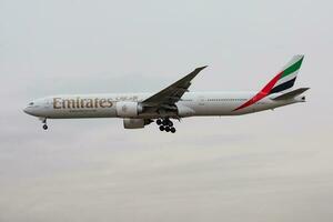 Emirates airlines Boeing 777-300ER A6-ECG passenger plane landing at Frankfurt Airport photo