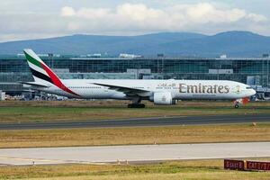 Emirates Airlines passenger plane at airport. Schedule flight travel. Aviation and aircraft. Air transport. Global international transportation. Fly and flying. photo