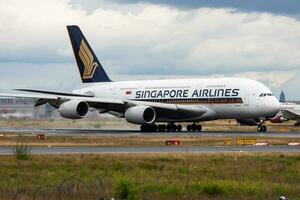 Singapore Airlines passenger plane at airport. Schedule flight travel. Aviation and aircraft. Air transport. Global international transportation. Fly and flying. photo