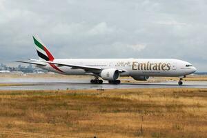 Emirates Airlines passenger plane at airport. Schedule flight travel. Aviation and aircraft. Air transport. Global international transportation. Fly and flying. photo