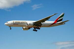 Emirates SkyCargo cargo plane at airport. Air freight shipping. Aviation and aircraft. Air transport. Global international transportation. Fly and flying. photo