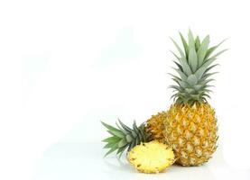 Ripe pineapple with green  leaves and sliced of fruit photo