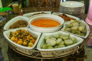 Ketupat sayur served at Eid Mubarak. Made from rice cake, rendang, coconut broth, and green chili photo