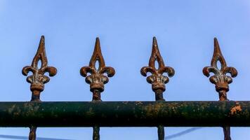 Old metal fashion fence. Decorative wrought iron fence. photo