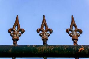 Old metal fashion fence. Decorative wrought iron fence. photo