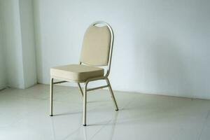 comfotable chair in empty white room. Empty chair at the room corner. loneliness concept photo