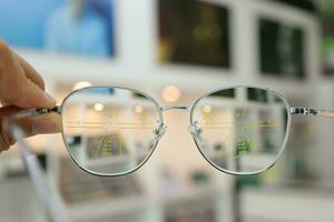 Hand holding glasses on blur background photo