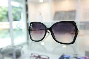 Black sunglass on table in optical shop photo