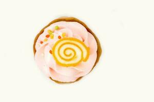 Top view of cute orange jelly on cupcake's cream and white background. photo