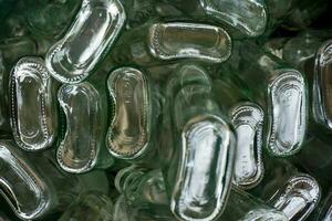 Closeup and crop bottom of flat glass bottle in full screen background photo