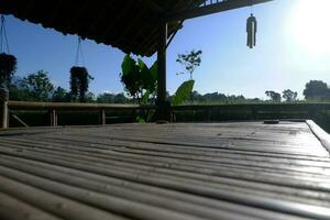 Bamboo Bells in a Hut With Views of Green and Beautiful Rice Fields and Beautiful Highlights of Morning Sunlight. photo