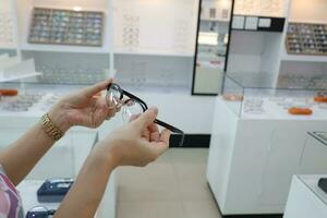 Hand holding glasses on blur background photo