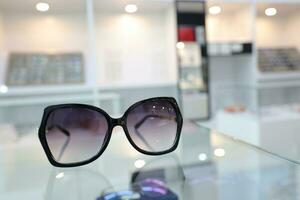 Black sunglass on table in optical shop photo