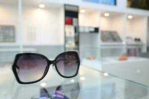 Black sunglass on table in optical shop photo