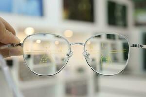 Hand holding glasses on blur background photo