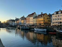 Nyhavn at sunset with colorful houses and boats photo