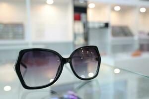 Black sunglass on table in optical shop photo