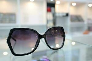 Black sunglass on table in optical shop photo