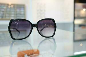 Black sunglass on table in optical shop photo