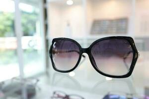 Black sunglass on table in optical shop photo