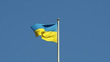 Ukrainian flag of Ukraine over blue sky photo