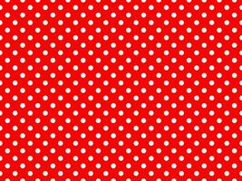white polka dots over red background photo
