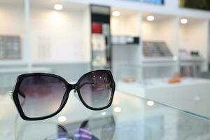 Black sunglass on table in optical shop photo