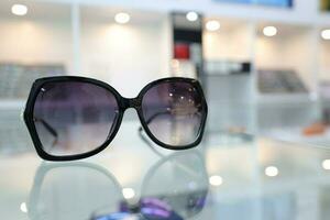 Black sunglass on table in optical shop photo