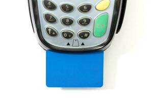 Credit card in payment terminal on white background photo